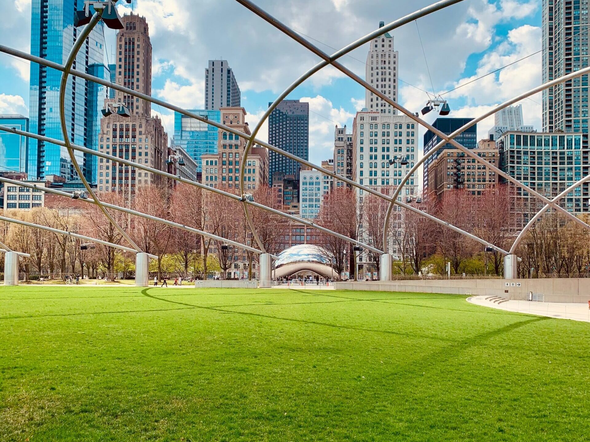 a large building with a green field