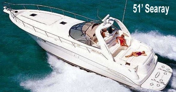 White yacht labeled '51’ Searay' cruising on blue water with people sunbathing on deck.